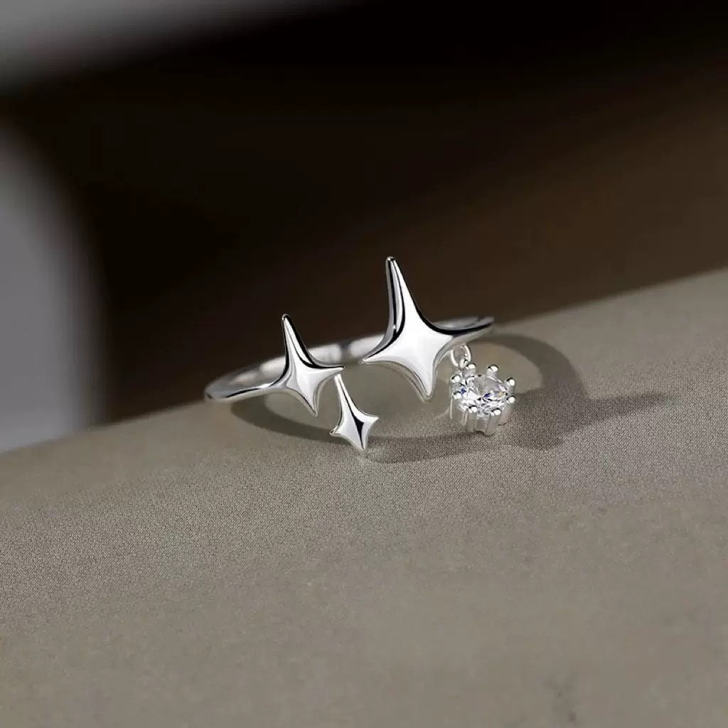 Adjustable sterling silver celestial ring with sparkling four point star details