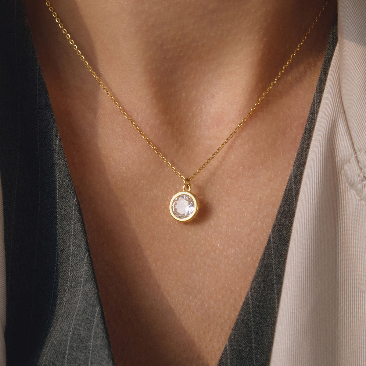 Gold tone stainless steel necklace with round cubic zirconia pendant for wholesale jewelry set buyers