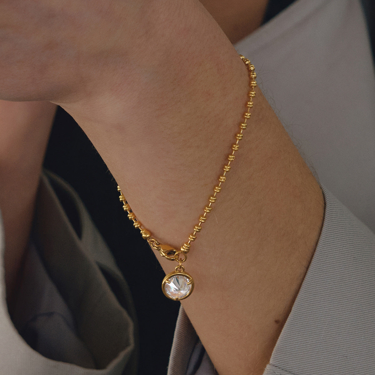 Gold tone stainless steel bracelet with round cubic zirconia stone detail for resale jewelry sets