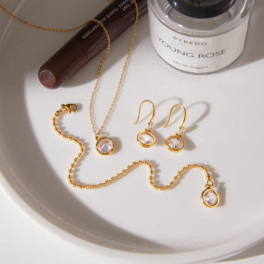 Coordinated stainless steel jewelry set with necklace bracelet and earrings featuring round cubic zirconia stones