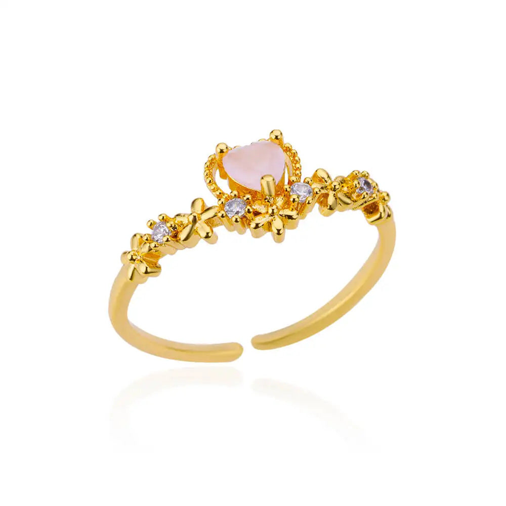 Adjustable gold tone open ring with pink heart stone and decorative crystal accents