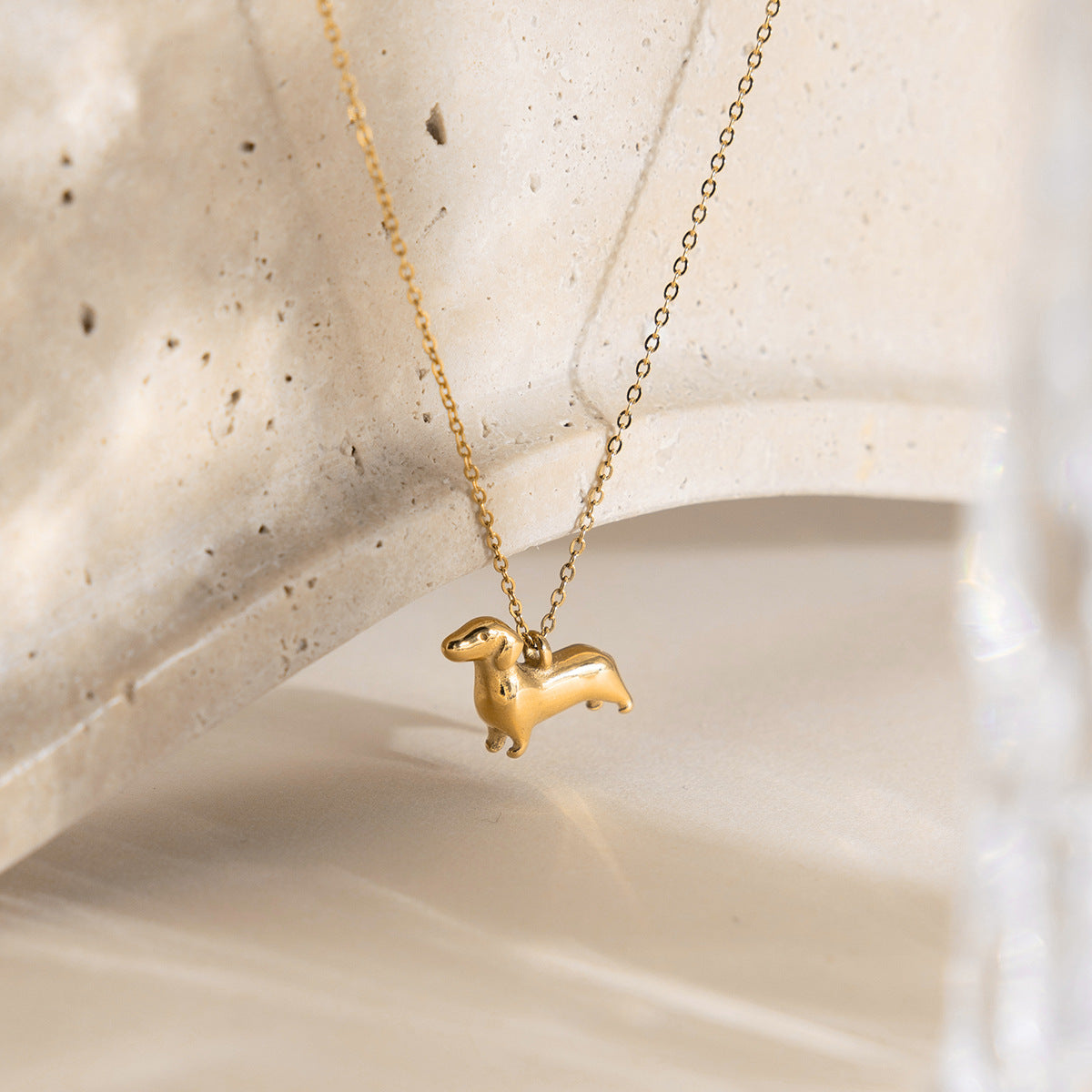 Cute dog pendant necklace styled with neutral background