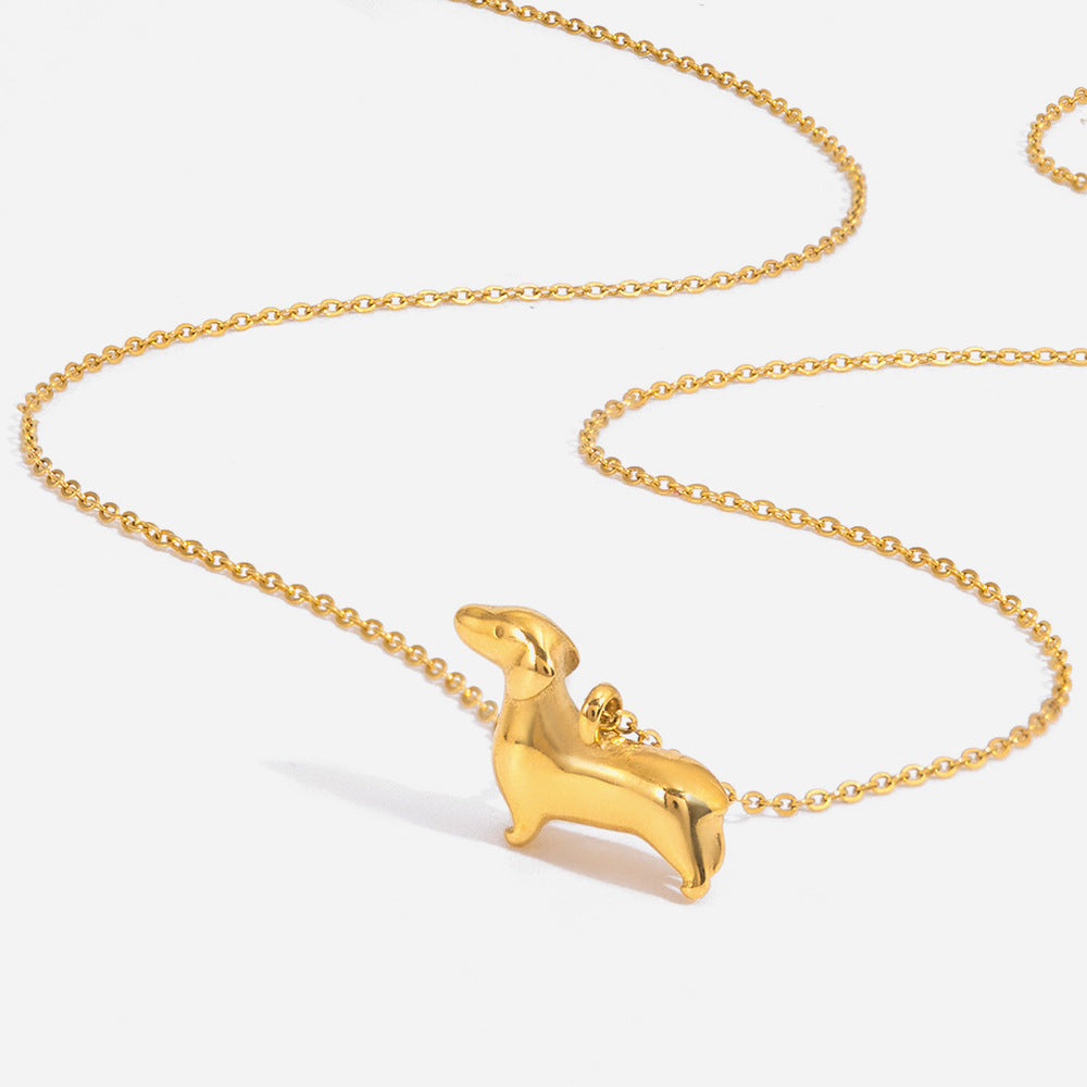 Gold tone stainless steel dog pendant necklace flat lay close up
