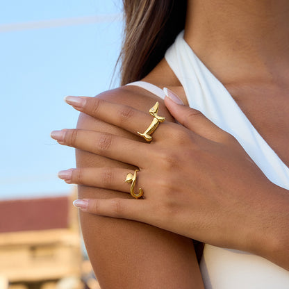 Model wearing gold dachshund and cat open rings for minimal animal themed styling