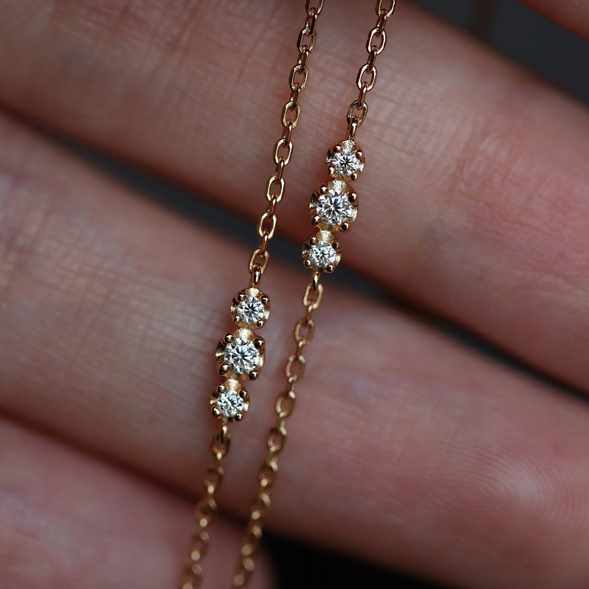 Ultra thin gold plated sterling silver bracelet with three cz stones on wrist for minimalist jewelry wholesale display