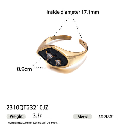 Gold tone open ring featuring black enamel and sparkling zircon accents
