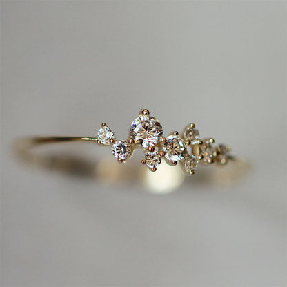 Close up of sterling silver ring featuring sparkling zircon cluster stones and 14K gold plating