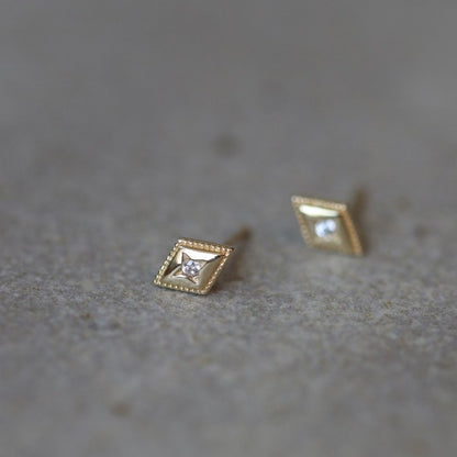 Diamond shaped stud earrings on ear
