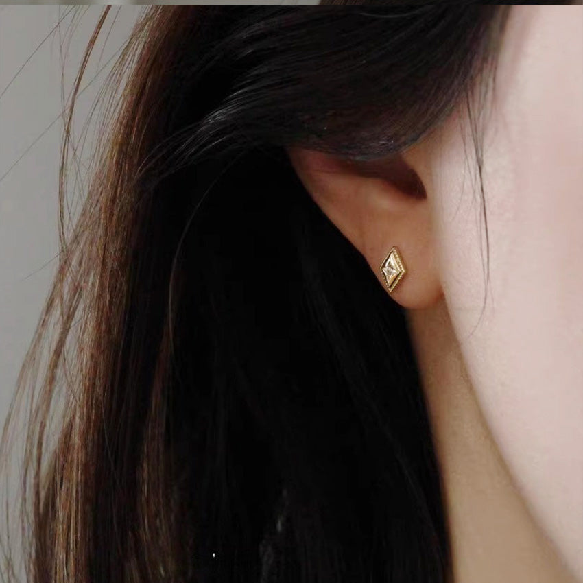 Diamond shaped stud earrings on ear