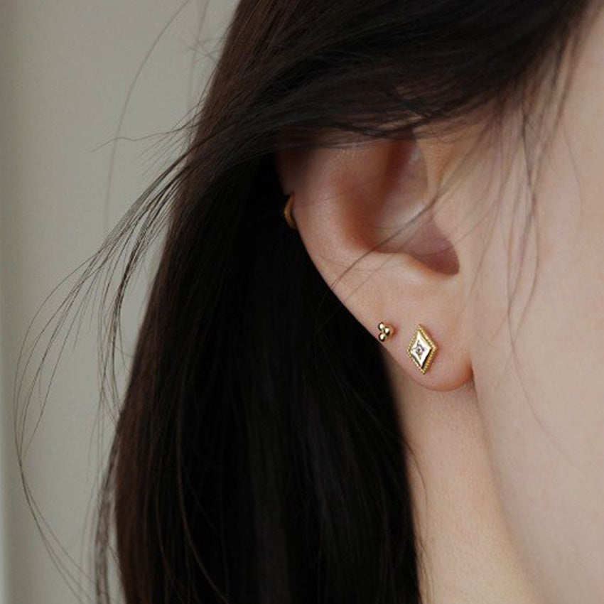 18K gold diamond shaped stud earrings close-up