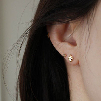 18K gold diamond shaped stud earrings close-up