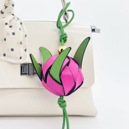 Handmade leather dragon fruit keychain on white background