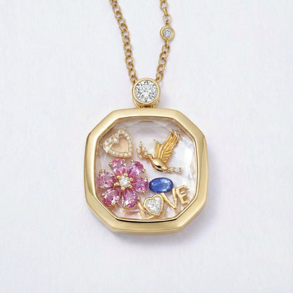 Close up of square glass memory locket pendant with floral heart and bird details on box chain necklace