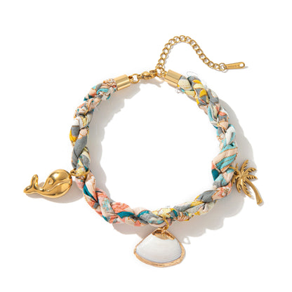 Floral braided ocean bracelet with palm charm and cowrie shell pendant gold plated