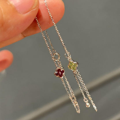 Three delicate sterling silver clover chain bracelets demonstrating elegant draping for boutique display