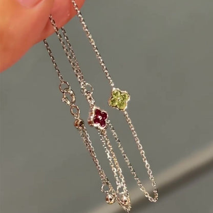 Dainty four leaf clover silver chain bracelets with sparkling cubic zirconia on hand for retail inventory showcase