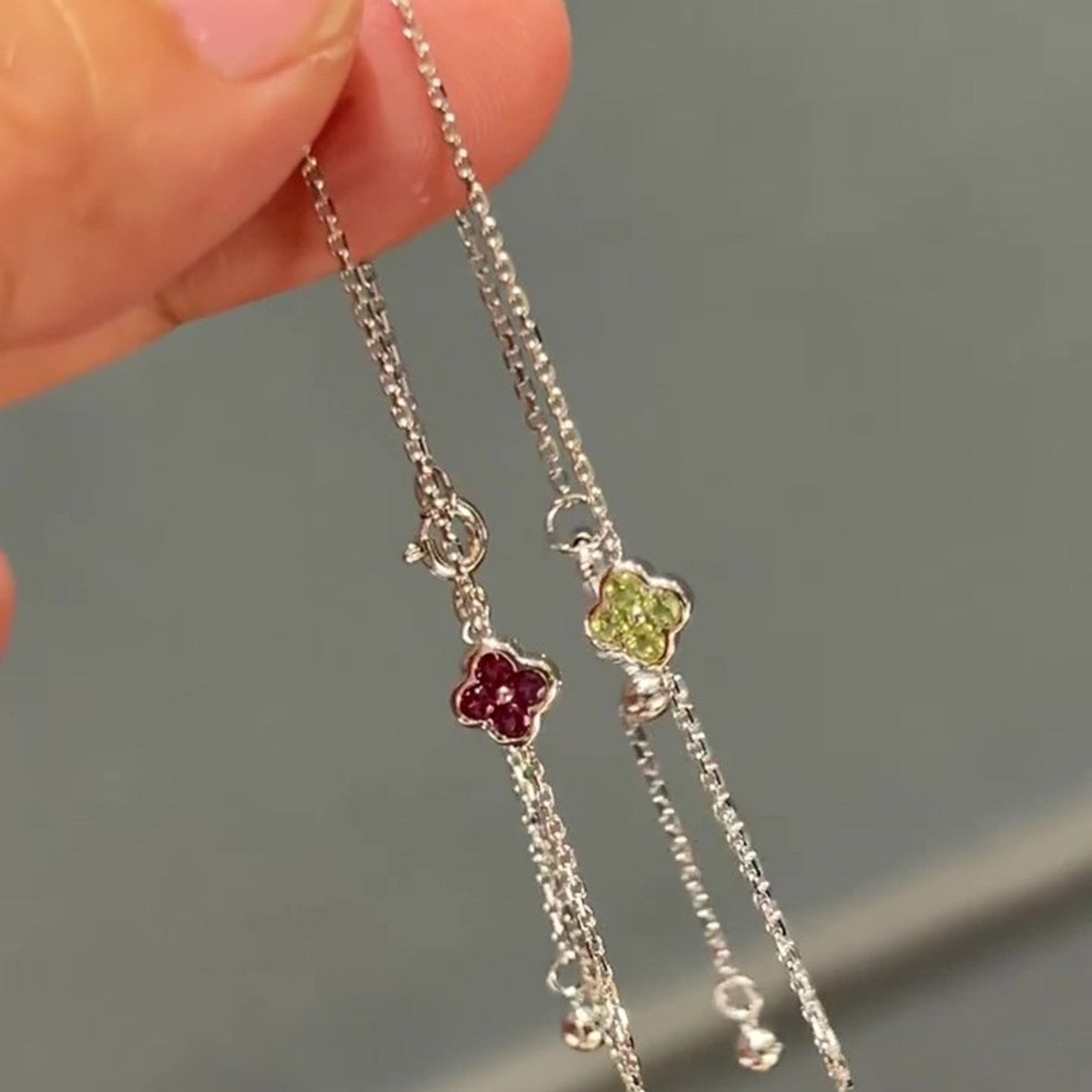 Close up of two minimalist S925 rhodium plated silver clover bracelets highlighting exquisite stone setting