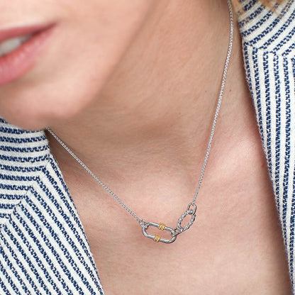 two tone knot pendant necklace worn on collarbone