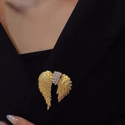 Gold double angel wings brooch with clear crystal center