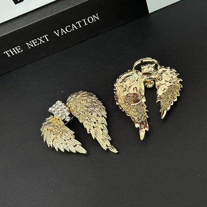 Back view of gold angel wings brooch with secure pin fastening