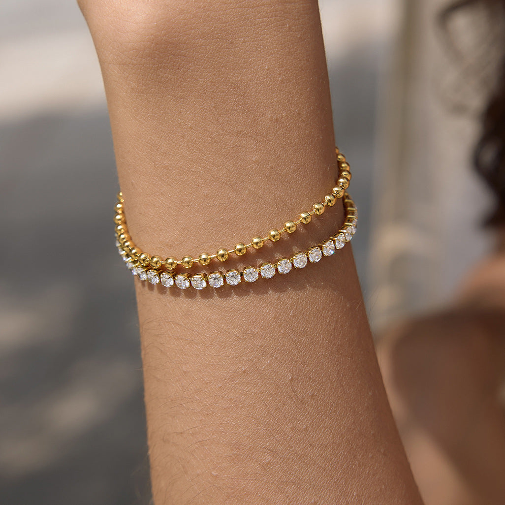 Close view of a waterproof gold stainless steel tennis bracelet with double row design