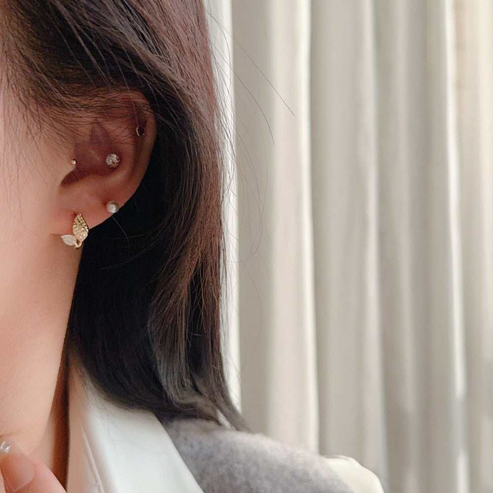 Nature inspired 18K gold plated leaf earrings with sparkling cubic zirconia accents and huggie hoop design