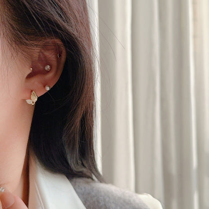 Nature inspired 18K gold plated leaf earrings with sparkling cubic zirconia accents and huggie hoop design