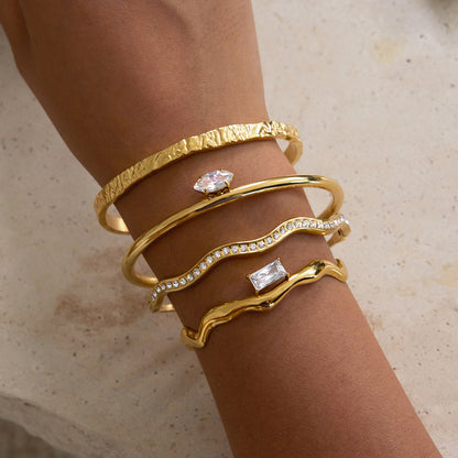  gold stainless steel open cuff bracelets worn together on wrist