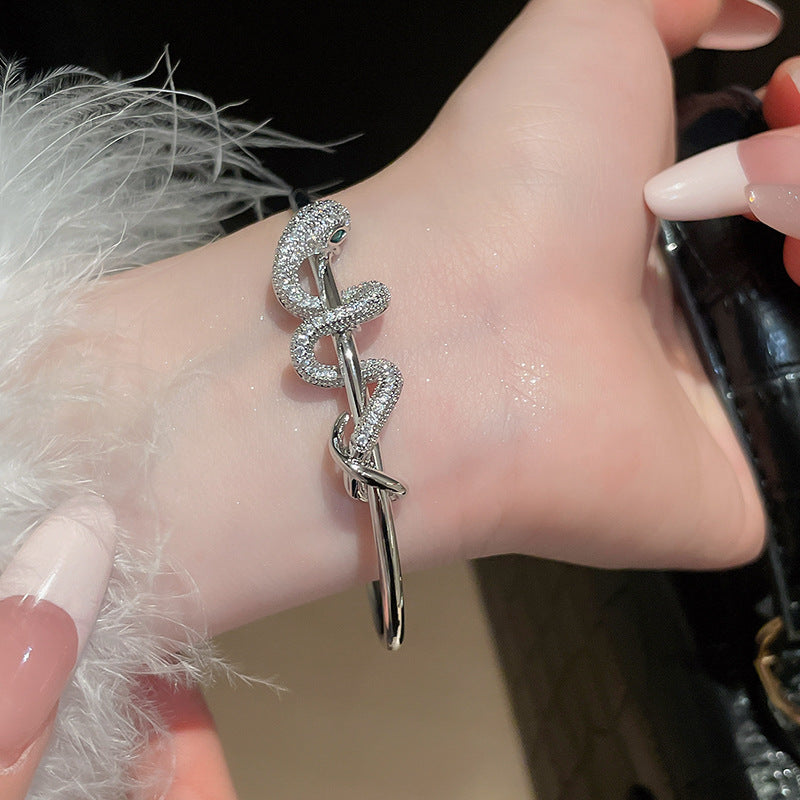 Silver CZ snake bracelet in gold plated brass, adjustable open bangle design for fashion jewelry wholesale.