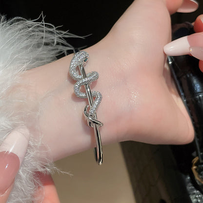 Silver CZ snake bracelet in gold plated brass, adjustable open bangle design for fashion jewelry wholesale.