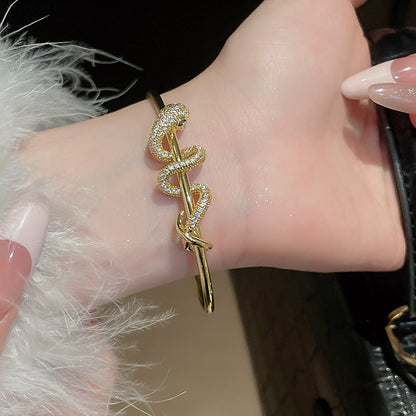 Gold plated snake bangle bracelet with cubic zirconia accents, luxury brass jewelry for boutiques and wholesale.