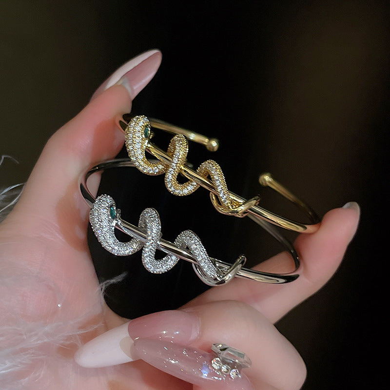 Pair of gold and silver CZ snake bangles, stylish gold plated brass bracelet design ideal for Christmas jewelry gift sets.