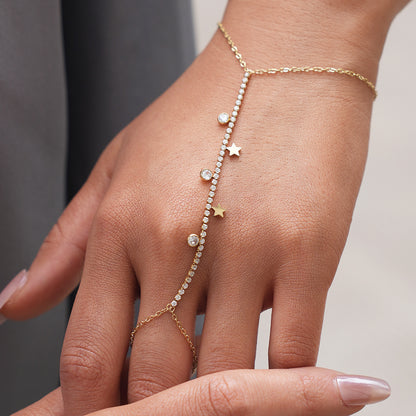 Gold star hand chain bracelet with cubic zirconia stones worn on the hand