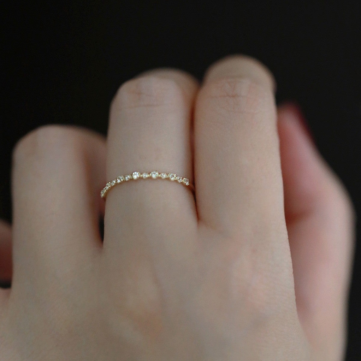 Detailed side view of delicate 14K gold plated zircon stacking ring with fine craftsmanship