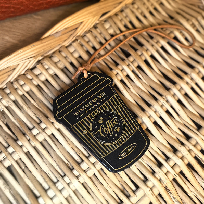 Handmade leather coffee cup bag charm wholesale keychain accessories displayed on wicker basket for coffee lover gift and Christmas gift for friends