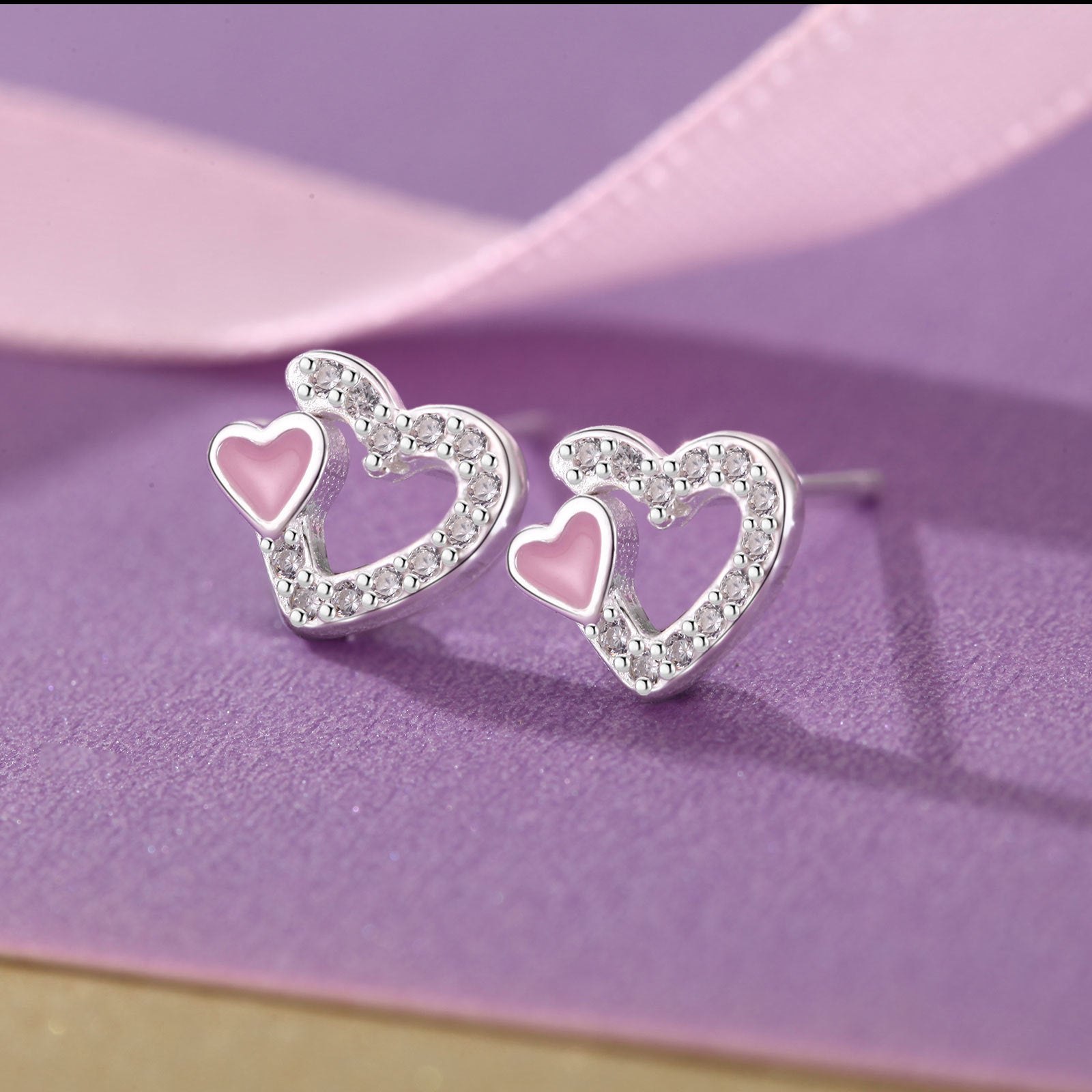 Detail shot of S999 silver pink heart enamel earrings for wholesale jewelry buyers