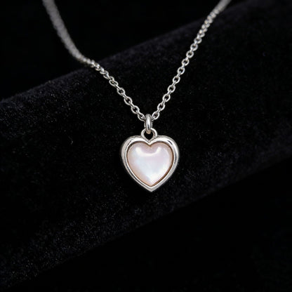 Close up detail of iridescent cat's eye stone heart pendant on S925 silver chain JR Fashion Accessories.