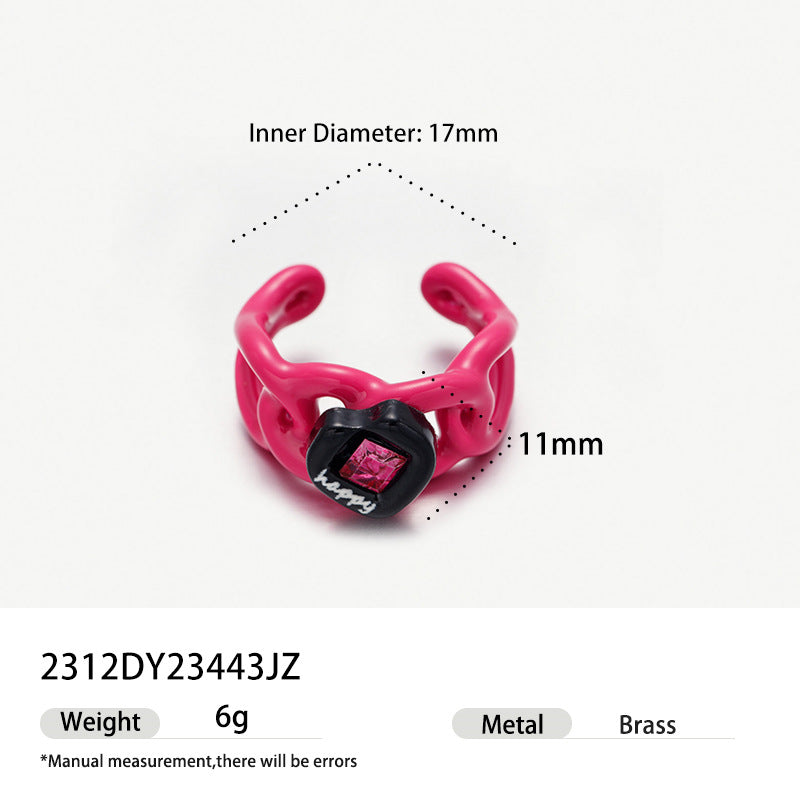 Hot pink flame shaped brass ring with black heart and pink crystal.