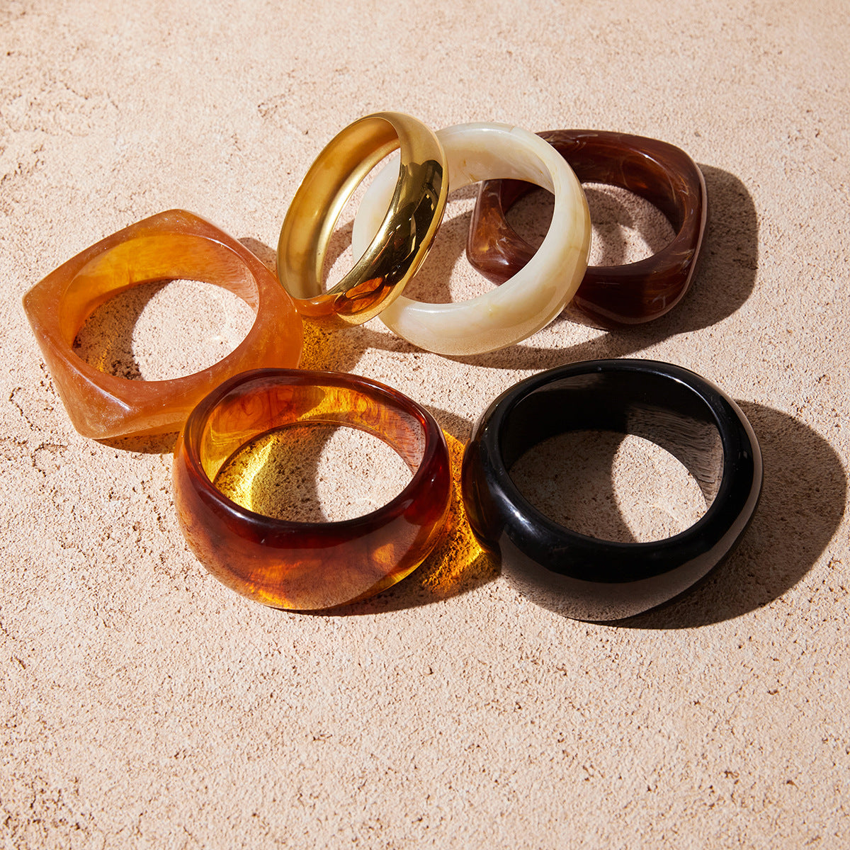 Assorted color wide resin bangles displayed together