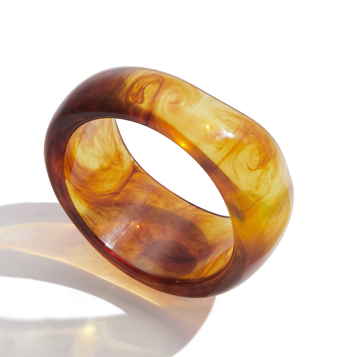 Amber color irregular wide resin bangle with polished finish