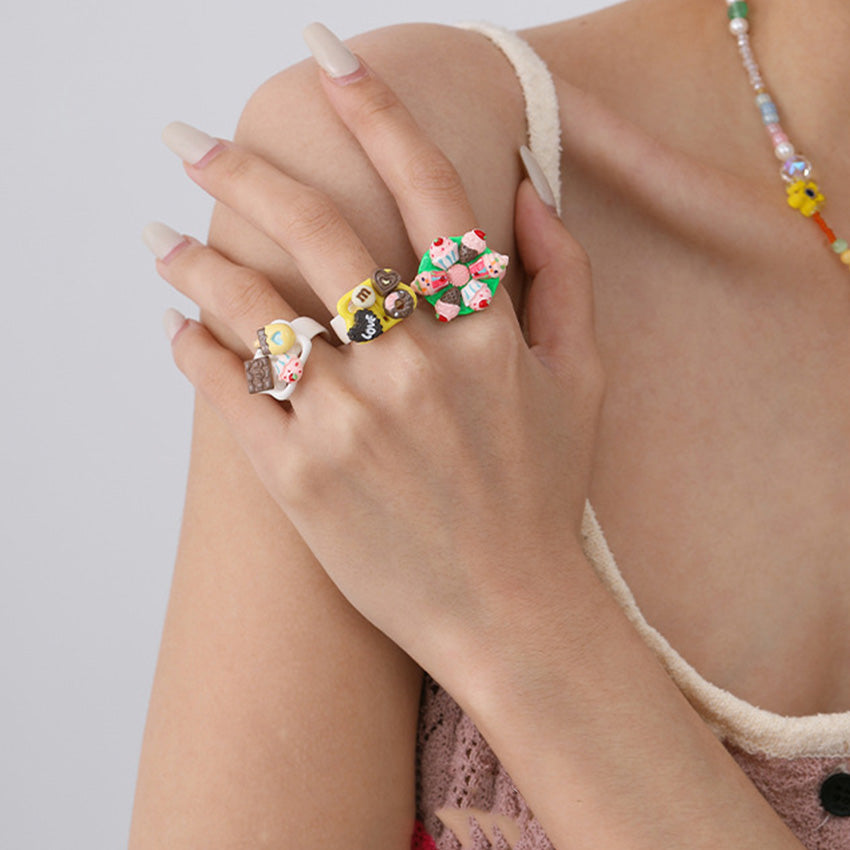 Model wearing colorful dessert themed adjustable fashion rings