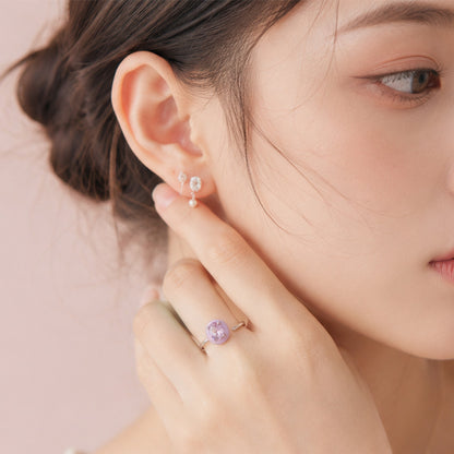 Model wearing a minimalist lavender zircon ring with adjustable band