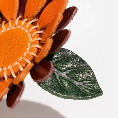Handmade leather sunflower keychain with green leaf, ideal for wholesale bag charms and seasonal gifts