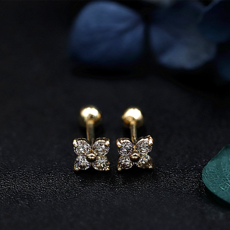 Close up of lucky clover earrings featuring cubic zirconia stones and secure screw back closure