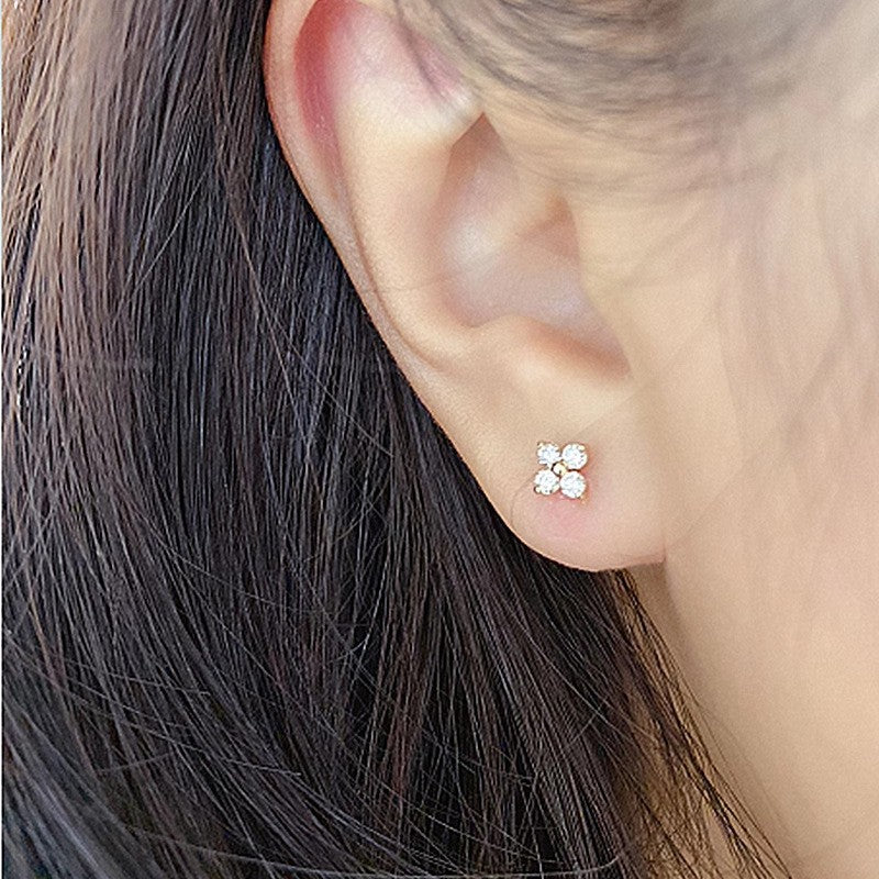 Woman wearing four leaf clover screw back earrings crafted from S925 sterling silver with 18K gold plating
