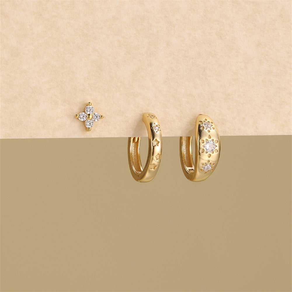 High resolution product shot of marquise diamond gold hoops and stud earring set on a neutral background.