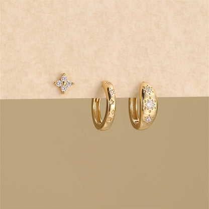 High resolution product shot of marquise diamond gold hoops and stud earring set on a neutral background.