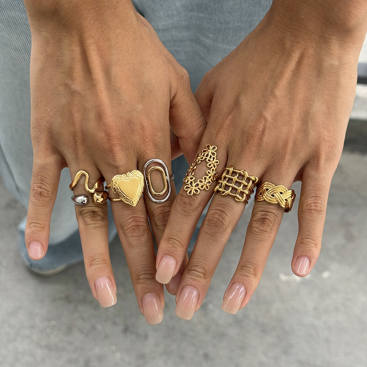 Mixed metal and gold stainless steel statement rings worn on both hands