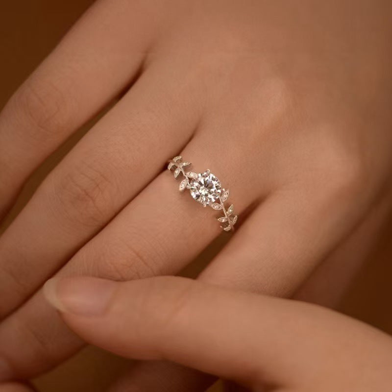 Woman wearing sterling silver goddess ring with 6MM zircon and botanical leaf design