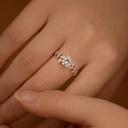 Woman wearing sterling silver goddess ring with 6MM zircon and botanical leaf design